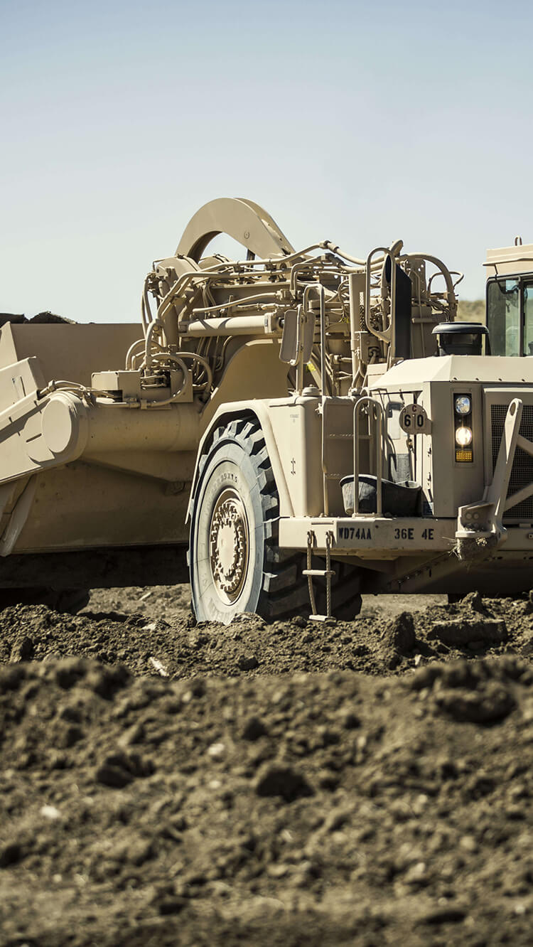 Backhoe digging on an Army construction site.